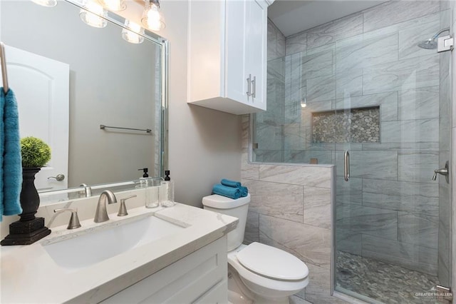 bathroom with vanity, toilet, and walk in shower