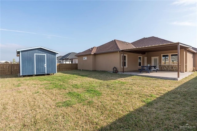 view of yard with a patio and a storage unit