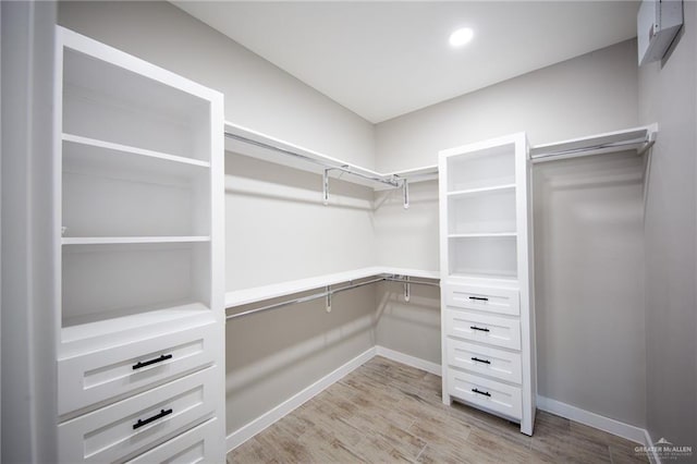 spacious closet with light hardwood / wood-style floors