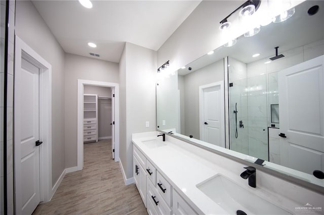 bathroom featuring vanity and an enclosed shower