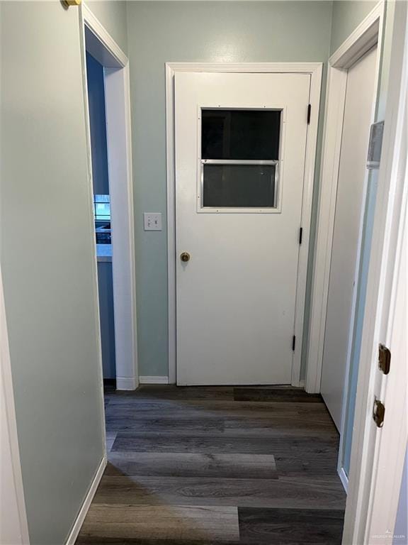 1601 S Oklahoma Ave, Weslaco, TX 78596 - hallway with dark wood-style flooring and baseboards