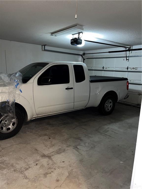 1601 S Oklahoma Ave, Weslaco, TX 78596 - garage featuring a garage door opener
