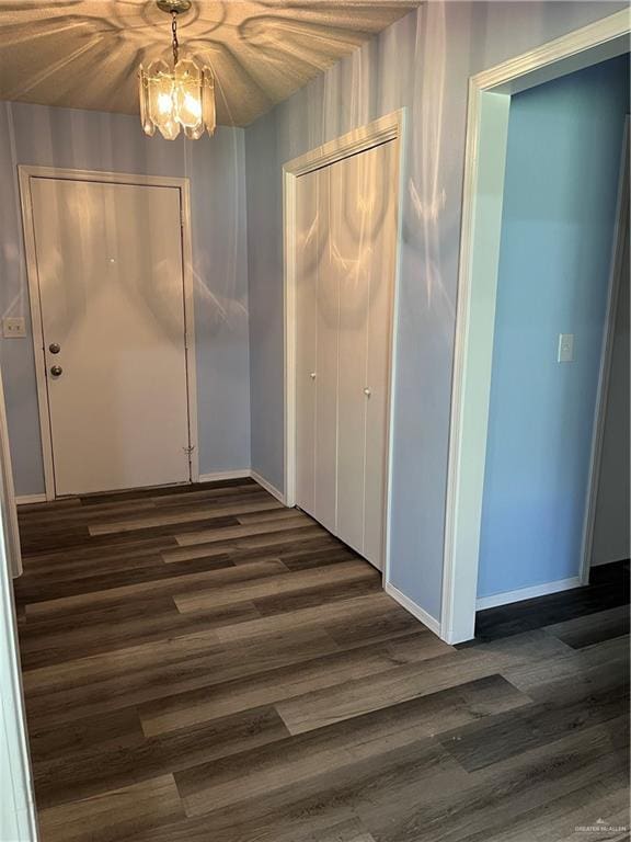 1601 S Oklahoma Ave, Weslaco, TX 78596 - unfurnished dining area with dark wood-style floors and a chandelier