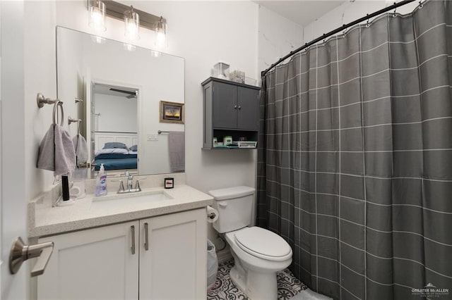 bathroom with tile patterned floors, vanity, curtained shower, and toilet