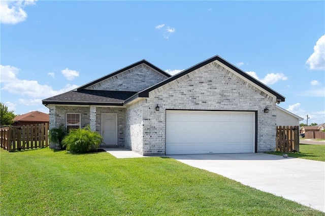 view of front of house featuring a garage and a front lawn