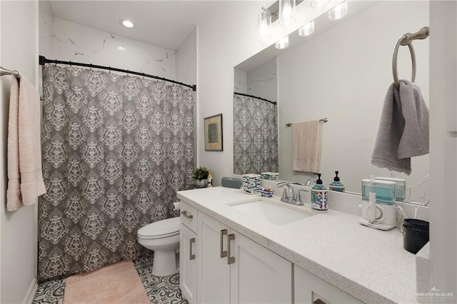 bathroom with tile patterned flooring, vanity, and toilet