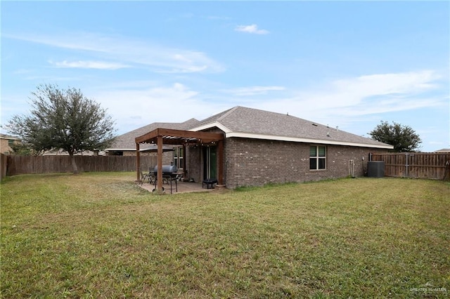 rear view of house with a lawn, central AC, and a patio area