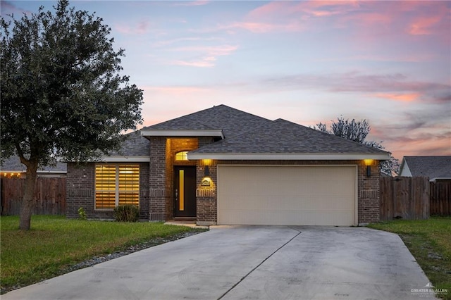 view of front of property featuring a yard and a garage