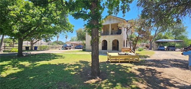 3220 N Taylor Rd, Mcallen, TX 78501 - view of front of house featuring stone siding, a detached carport, and a balcony