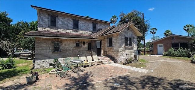 3220 N Taylor Rd, Mcallen, TX 78501 - view of front of property featuring stone siding and a patio area