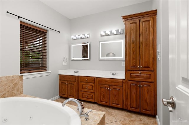 bathroom featuring tile patterned flooring, vanity, and a tub