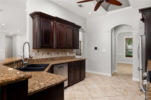 kitchen featuring backsplash, decorative columns, dark brown cabinetry, stainless steel appliances, and crown molding