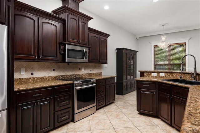 kitchen featuring sink, hanging light fixtures, a notable chandelier, dark brown cabinets, and stainless steel appliances