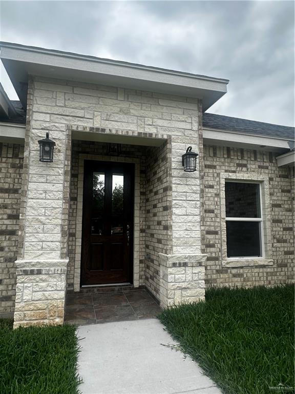 doorway to property with stone siding