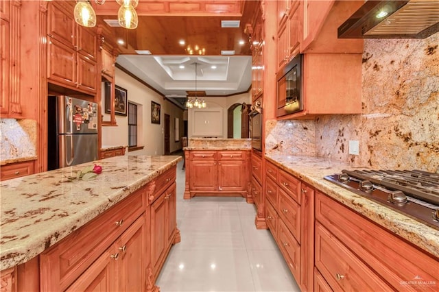 kitchen featuring appliances with stainless steel finishes, tasteful backsplash, custom exhaust hood, a raised ceiling, and decorative light fixtures