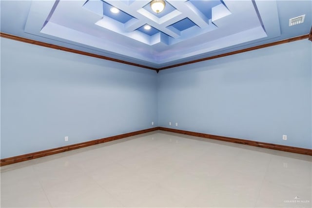 empty room featuring coffered ceiling, tile patterned flooring, ornamental molding, and a tray ceiling