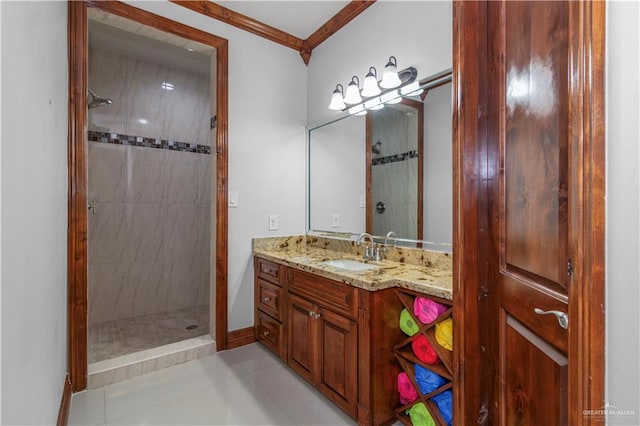 bathroom featuring tiled shower, vanity, tile patterned floors, and crown molding