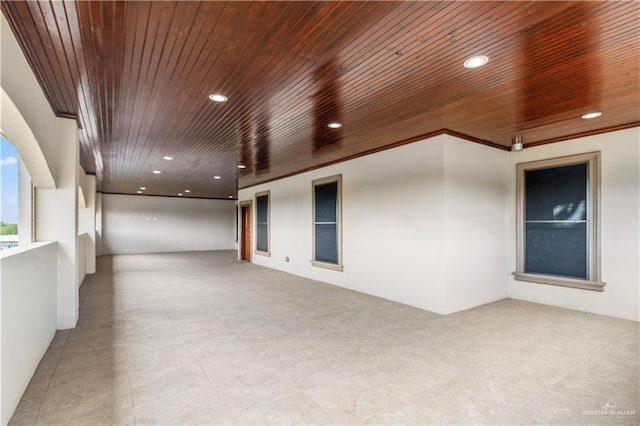 unfurnished room with crown molding and wood ceiling