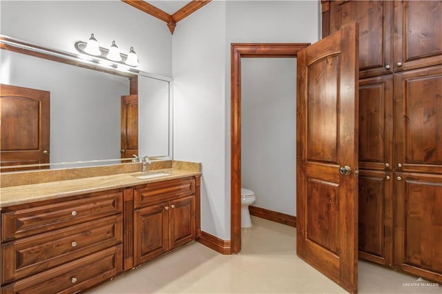 bathroom with crown molding, vanity, and toilet