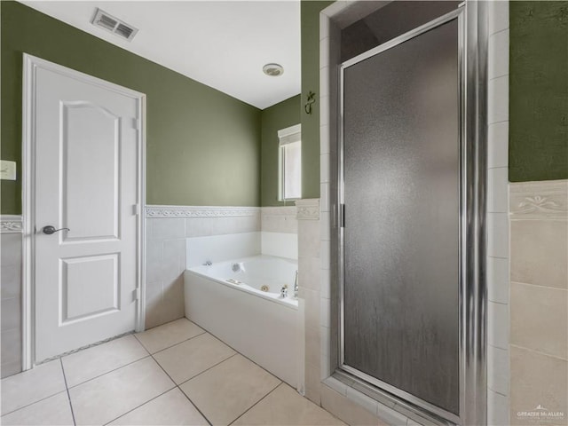 bathroom featuring visible vents, tile walls, a tub with jets, tile patterned floors, and a shower stall