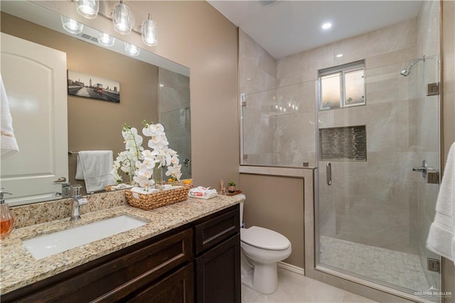 bathroom with tile patterned flooring, vanity, toilet, and walk in shower