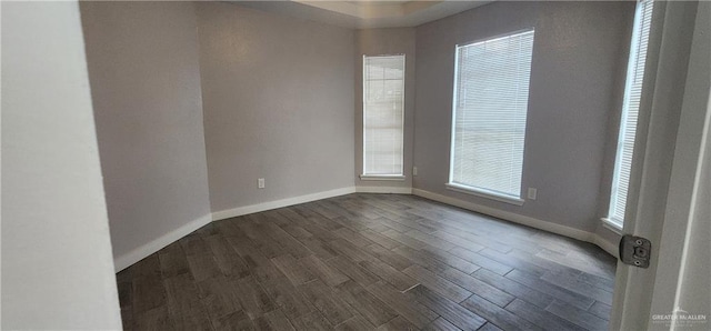 spare room featuring dark hardwood / wood-style flooring