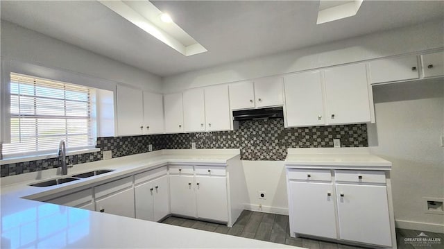 kitchen featuring white cabinetry, sink, tasteful backsplash, and dark hardwood / wood-style flooring