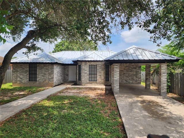 421 Casiano St, Donna, TX 78537 - view of front of property featuring driveway, metal roof, a carport, and a standing seam roof