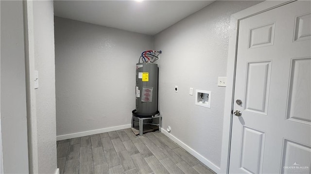 laundry room with electric dryer hookup, hookup for a washing machine, electric water heater, and light wood-type flooring