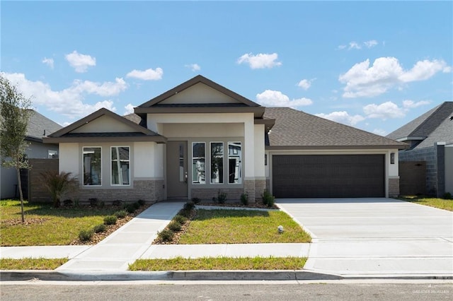 view of front of home featuring a garage and a front yard