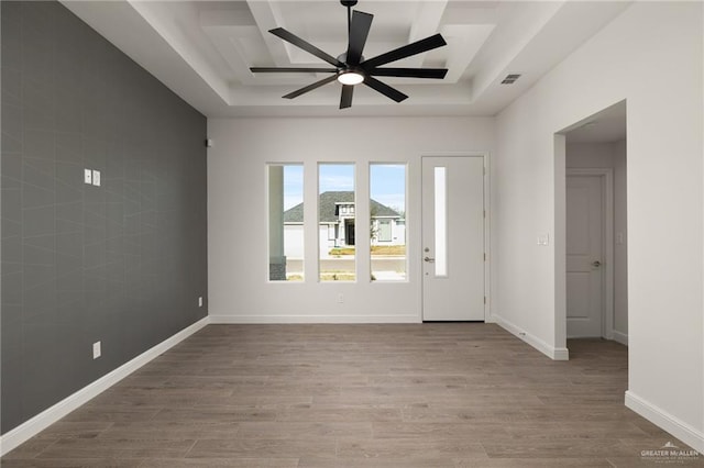 entryway featuring a tray ceiling, ceiling fan, and hardwood / wood-style flooring