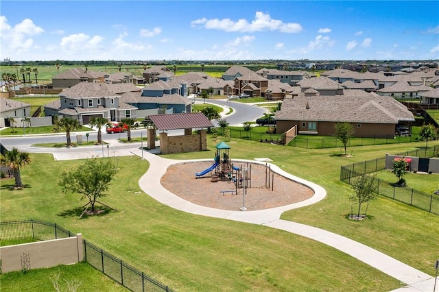 surrounding community with fence, a lawn, and a residential view
