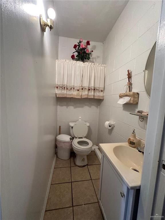 bathroom with tile patterned floors, vanity, and toilet