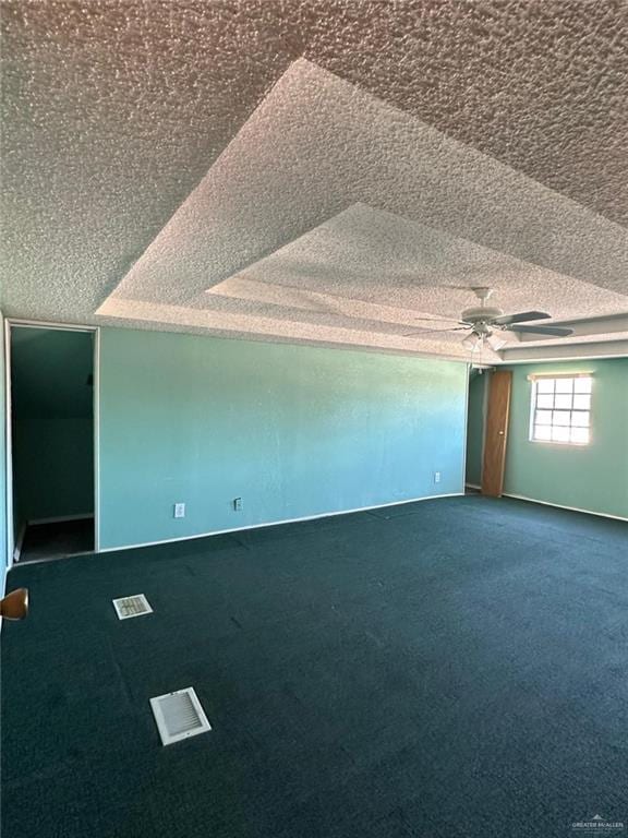 bonus room featuring ceiling fan, carpet floors, and a textured ceiling