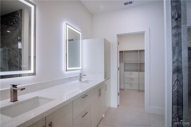 bathroom with vanity and a shower