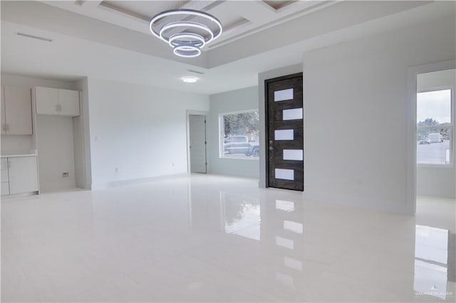 interior space featuring a chandelier and coffered ceiling