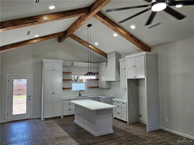 kitchen featuring open shelves, custom range hood, a kitchen island, a ceiling fan, and recessed lighting