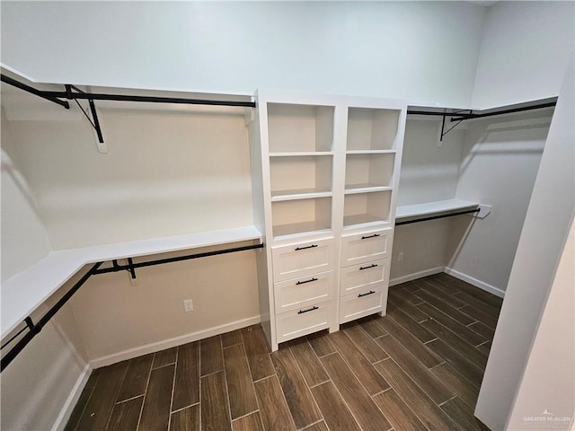 walk in closet with wood finish floors