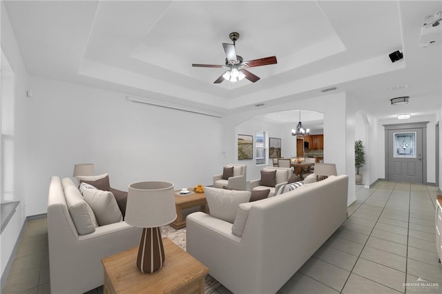 3817 Frontier Dr, Edinburg, TX 78539 - living area with a raised ceiling, arched walkways, light tile patterned floors, a chandelier, and ceiling fan