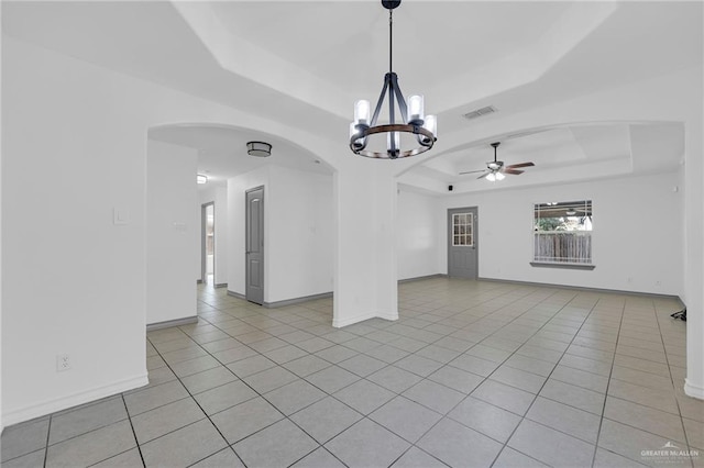 3817 Frontier Dr, Edinburg, TX 78539 - spare room featuring a raised ceiling, arched walkways, ceiling fan, a chandelier, and light tile patterned flooring