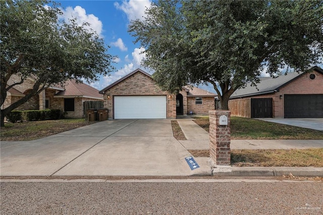 3817 Frontier Dr, Edinburg, TX 78539 - ranch-style home with concrete driveway, an attached garage, and brick siding