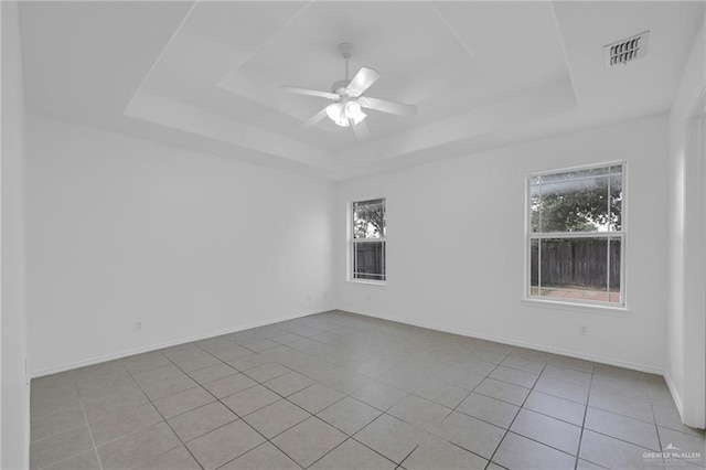 3817 Frontier Dr, Edinburg, TX 78539 - unfurnished room with a tray ceiling, plenty of natural light, tile patterned floors, and ceiling fan