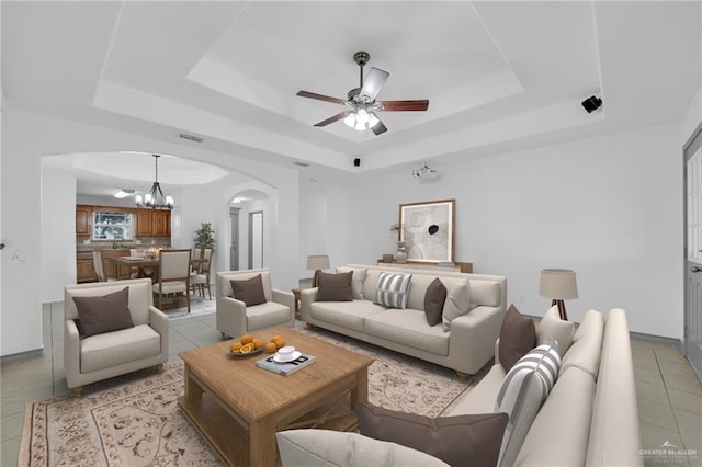 3817 Frontier Dr, Edinburg, TX 78539 - living room with a raised ceiling, arched walkways, a chandelier, and light tile patterned floors