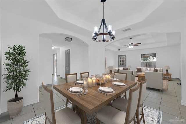 3817 Frontier Dr, Edinburg, TX 78539 - dining space featuring a raised ceiling, arched walkways, ceiling fan, and light tile patterned floors