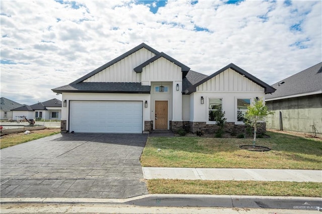 modern farmhouse featuring a garage and a front lawn