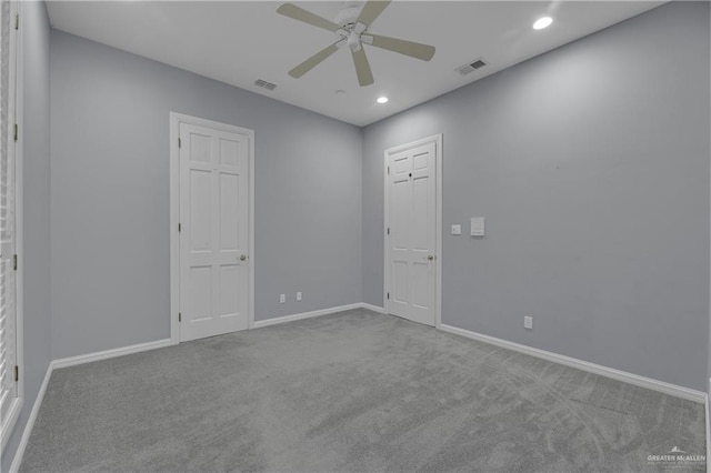 spare room featuring carpet and ceiling fan