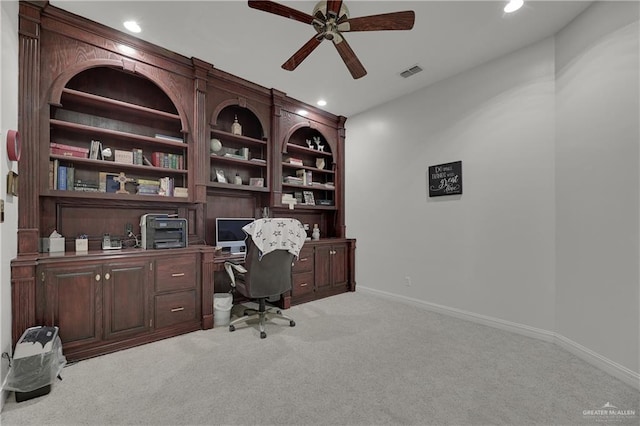 carpeted home office with ceiling fan