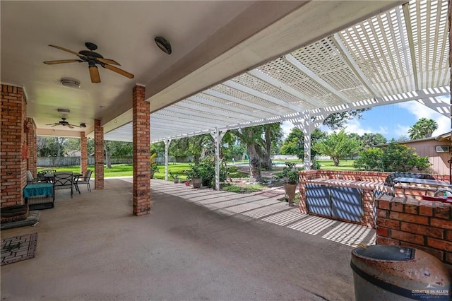 view of patio with ceiling fan and a pergola