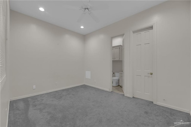 unfurnished bedroom with ensuite bath, ceiling fan, and light carpet