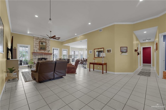 tiled living room featuring ceiling fan, plenty of natural light, ornamental molding, and a fireplace